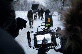 Shooting a feature film, backstage on the set in the street in the winter, the view from the camera. The work of the cameraman
